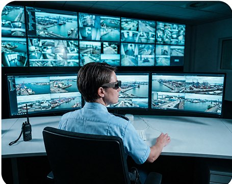 Illustrative mobile command operator viewing multiple monitoring screens